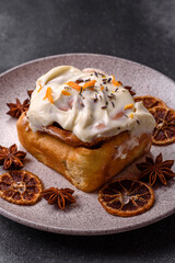 Cinnabon, a sweet cinnamon pastry, a high calorie bun or roll. Cinnabon with cinnamon