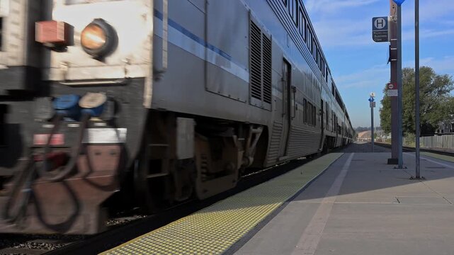 Commuter train arriving at station with audio.