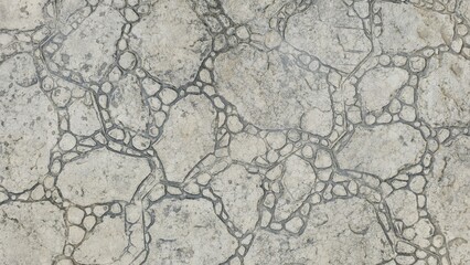The old grey stone floor has natural cracks and irregular patterns. It is damp from light rain, giving it a dark and wet texture, suitable for use as a background or pattern.