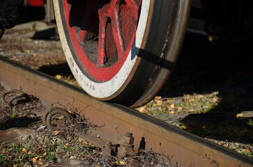 wheel of an old steam locomotive on railway rails close-up