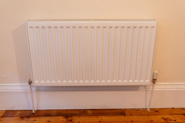 White radiator against beige wall