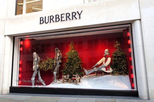A festive Christmas campaign is displayed in the Burberry store window in New Bond Street, London. Burberry is a prestigious British luxury clothing brand.