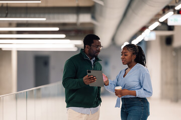 Business professionals discussing work using digital tablet