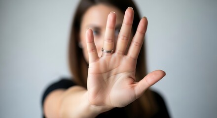 Focused Gesture: A person, with outstretched palm and raised fingers, exudes an aura of intent, commanding attention and setting boundaries.
