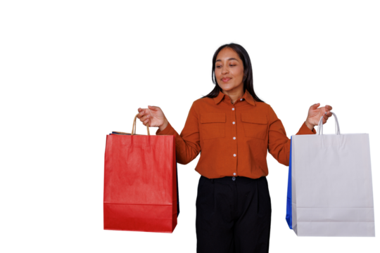 Young woman carrying various shopping bags, smiling and enjoying the experience, expressing satisfaction with her consumer choices. Transparent background