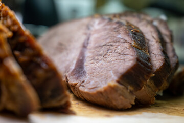 Extreme close-up of tender sliced roast beef. Selective focus highlights the savory meat texture, perfect for culinary and food-related concepts.