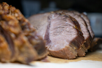 Extreme close-up of tender sliced roast beef. Selective focus highlights the savory meat texture, perfect for culinary and food-related concepts.