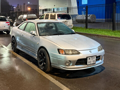 Silver Japanese sport car Toyota Sprinter Trueno (110) at the city street. Exterior of a fast Japanese two-door coupe Toyota Sprinter Trueno on parking lot. JDM sport car. 