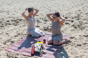 Two Caucasian women on a picnic on the beach. 