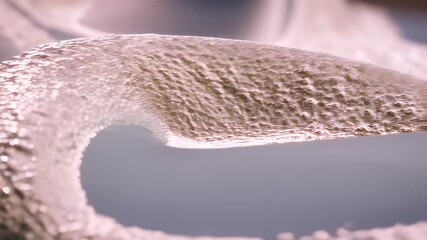 Discover the intricate details of this mesmerizing video, which showcases a close-up view of textured surfaces. The soft curves and subtle shadows create a fascinating visual experience that highlight