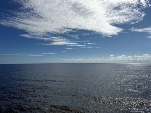 Open sea, blue sky and beautiful clouds.