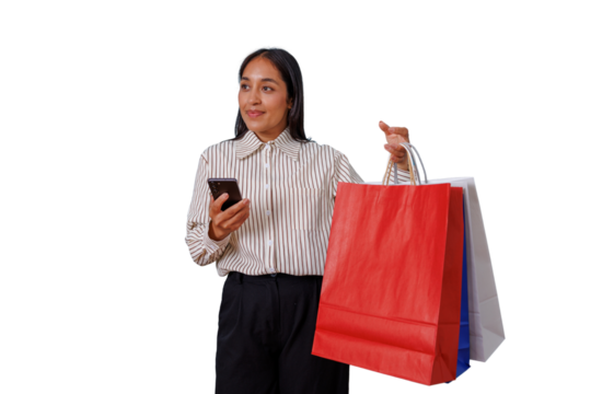 Young woman smiling, holding shopping bags and using smartphone for online shopping or mobile banking on transparent background - Powered by Adobe