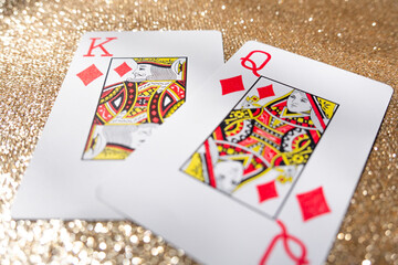 Photograph of a set of king and queen playing cards on a gold background