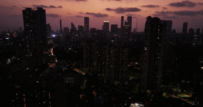 Cinematic aerial view of Mumbai's downtown night scene. Central Mumbai's cityscape and skyline- Lalbaug-Parel, Worli, Prabhadevi. beautiful modern buildings, bright glowing lights, and roads.