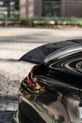 fast black german car with a spoiler in the back, beautiful shape