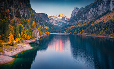 Aerial landscape photography. Wonderful autumn view from flying drone of Gosausee (Vorderer) lake with Dachstein glacier on background. Exciting evening scene of Austrian Alps, Upper Austria, Europe.