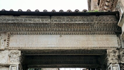 Rome, Italy – 11 January 2025. Latin inscription carved into the Arch of Janus, framed by...