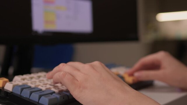 Hands input data swiftly, Closeup of fingers editing spreadsheet details, Person rapidly typing on vibrant keyboard while managing data on colorful digital display
