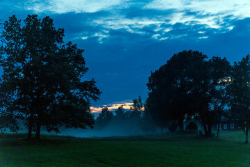 Dusk arriving in the Swedish countryside with rising mist