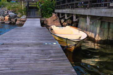 Yellow rowing boat moored at Axmar wooden dock