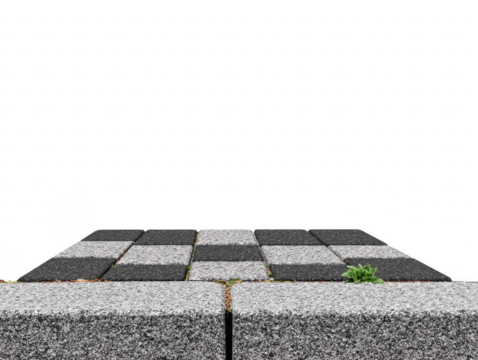 Checkerboard stone pavement with gray and black square tiles, some grass growing between cracks, outdoor ground surface, urban sidewalk, clean and minimal design