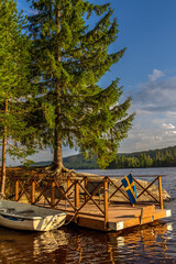 Swedish flag flying on a wooden lake dock