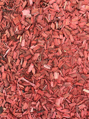 Close-up of Red wood Chips backdrop. Natural Mulch background for garden design and eco-projects. Bark texture macro. Wooden Surface for packaging. Landscape design for site decoration. Vertical photo