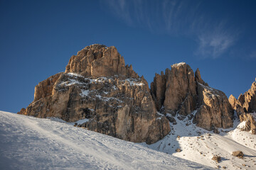 Snow-Covered Nature in the Dolomites, Italy, with a Rock Formation Under a Clear Blue Sky. Sunny Day with Rocky Peak during Winter Season in Europe.