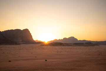 Evening Scenery with Sunset Sun and Rocky Mountain in Wadi Rum. Jordanian Desert with Sandy Surface and Rock in the Middle East.
