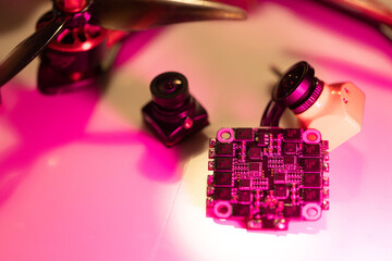 essential fpv drone components including flight controller, camera, and propellers arranged on a surface, neutral background, clear negative space, clean composition, balanced framing, minimalist