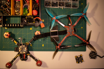 overhead view of a workbench filled with fpv drone components and tools, showcasing various parts and accessories for building and repairing drones, neutral background, clear negative space, clean
