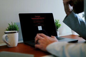 Middle Aged Executive Man Working From Home Falls Victim to Spear Phishing Ransomware Attack - Common Cybersecurity Scenario Concept