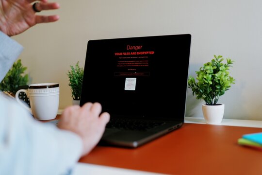 Middle Aged Executive Man Working From Home Falls Victim to Spear Phishing Ransomware Attack - Common Cybersecurity Scenario Concept