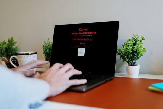 Middle Aged Executive Man Working From Home Falls Victim to Spear Phishing Ransomware Attack - Common Cybersecurity Scenario Concept