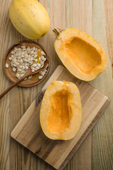 Overhead view of Spaghetti squash on a wooden background with squash seeds