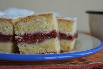 Homemade sliced cherry pie sprinkled with powdered sugar. Closeup view.