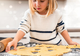 Little Girl Cutting Christmas Cookie Dough Shapes
