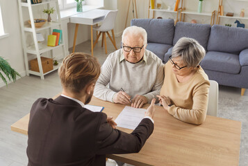 Senior older couple and agent consulting, reviewing document, explaining details discussing important paper, focused serious financial legal consultation, planning decision, professional guidance 