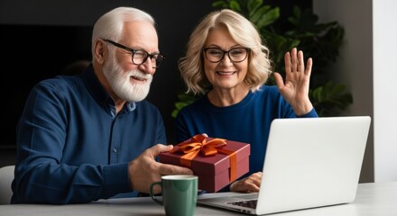 Elderly couple celebrating occasion with laptop and gift box at home