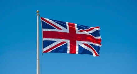 Union Jack in the Sky: The iconic Union Jack flag gracefully unfurls against a clear blue sky, its vibrant colors representing the spirit and heritage of the nation. 