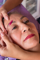 Portrait of a Colombian woman customer receiving professional eyelash services inside a beauty salon in Neiva, Huila, Colombia. Concept of handmade