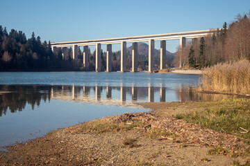 An overpass passing over a calm lake in Fuzine, Croatia