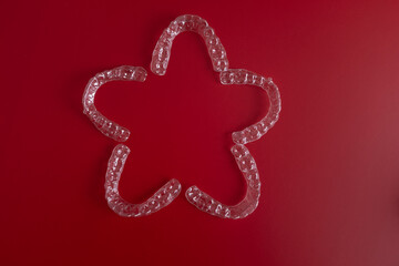 Invisible orthodontics cosmetic brackets on blue background. Tooth aligners, for beautiful smile. This invisible aligner showcases a modern approach to orthodontics and confidence in her appearance.