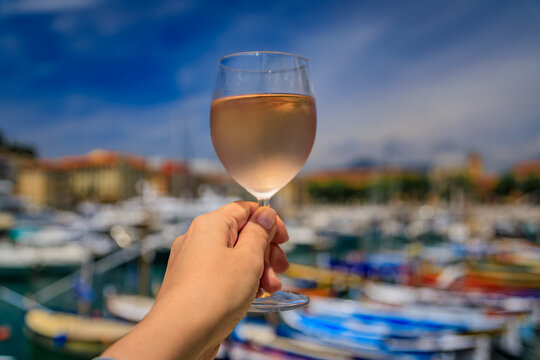 Raspberry lambic ale, old blurred buildings in background, Old Town Nice, France