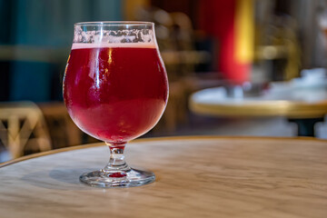 Raspberry lambic ale, old blurred buildings in background, Old Town Nice, France