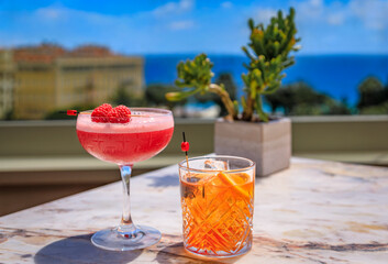 Raspberry champagne cocktail and an old fashioned at a rooftop bar, Nice, France