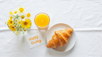 Start your happy Friday with a fresh croissant, orange juice, and vibrant flowers for a delightful morning treat on a beautiful day