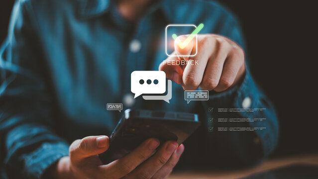 Person using smartphone with glowing feedback and chat icons, symbolizing online survey, customer review, digital communication, and technology interaction in modern business concept. - Powered by Adobe