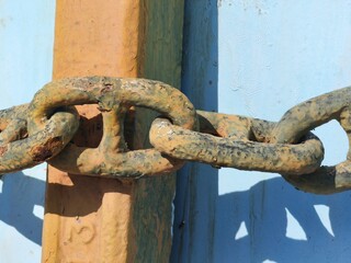 Rusty Heavy Metal Chain on Corroded Industrial Surface
