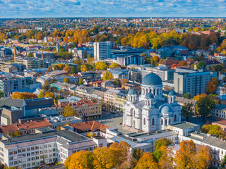Naklejka premium Soboras - St. Michael the Archangel Church Sobor. Aerial drone view photo of Kaunas city center and Laisves aleja, Liberty avenue in Kaunas. Autumn